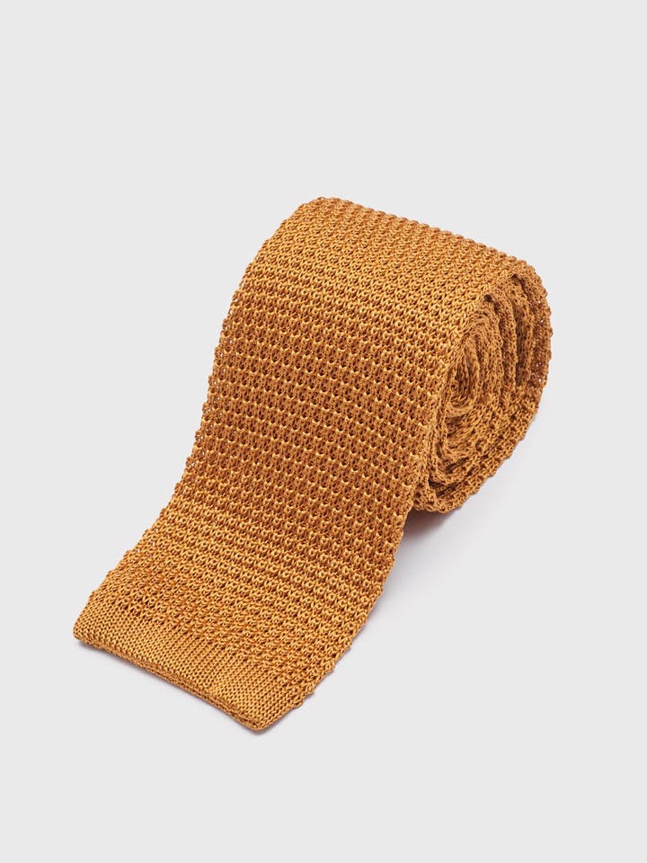 Knitted silk tie ochre rolled